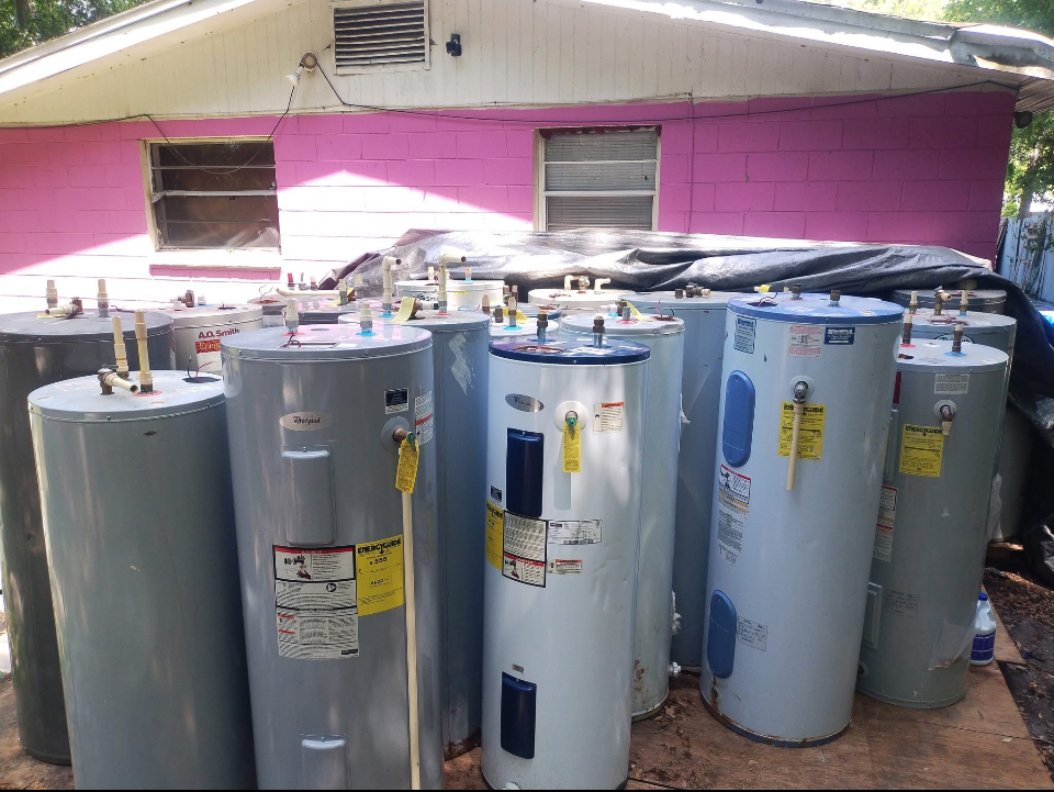 Row of electric water heater tanks ready for installation