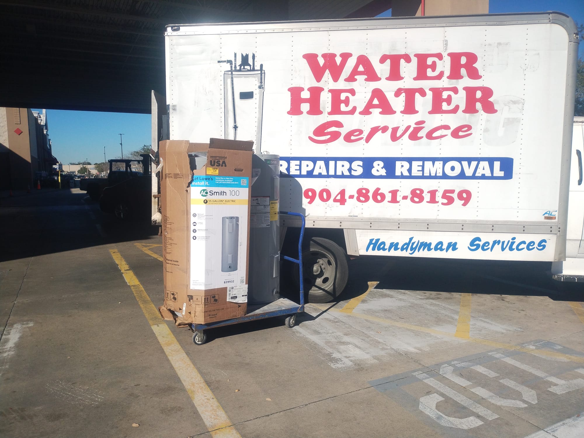 Teater's Water Heaters service truck with a new A.O. Smith water heater on a dolly